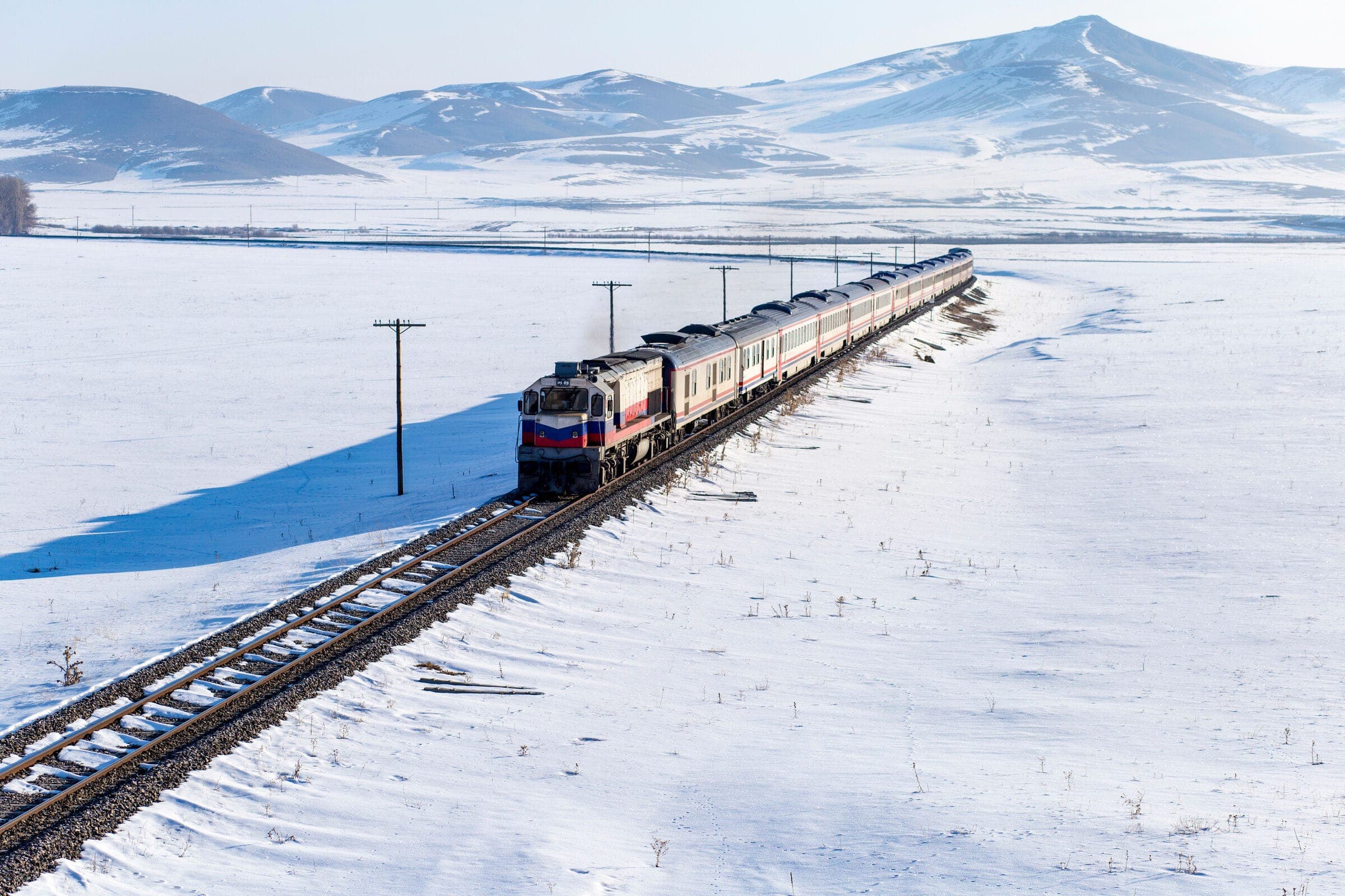 A train crossing a snowy steppe